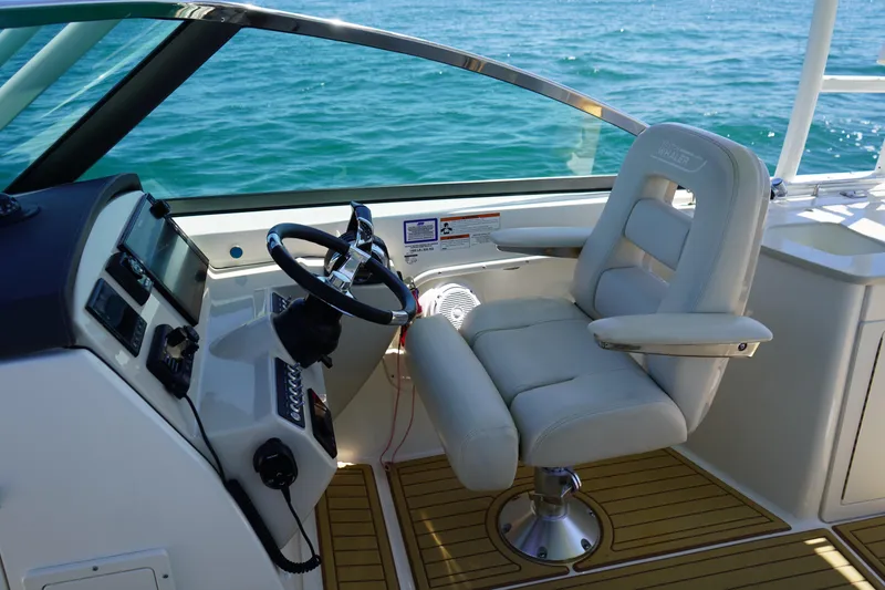 Slide: The Image of 2019 Boston Whaler 270 Vantage helm with luxurious seating and ocean view. - 13