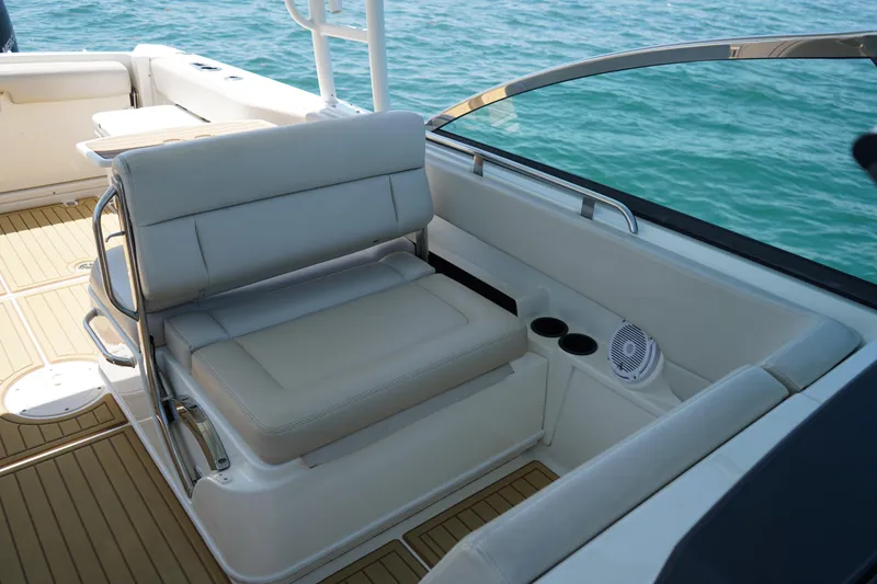 Slide: The Image of 2019 Boston Whaler 270 Vantage boat interior with cushioned seating and ocean view. - 15