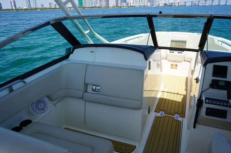 Slide: The Image of 2019 Boston Whaler 270 Vantage boat interior with city skyline in background. - 16