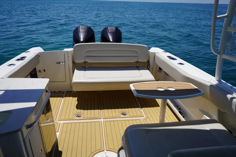 Slide: The Image of 2019 Boston Whaler 270 Vantage boat interior with seating and table on open water. - 19