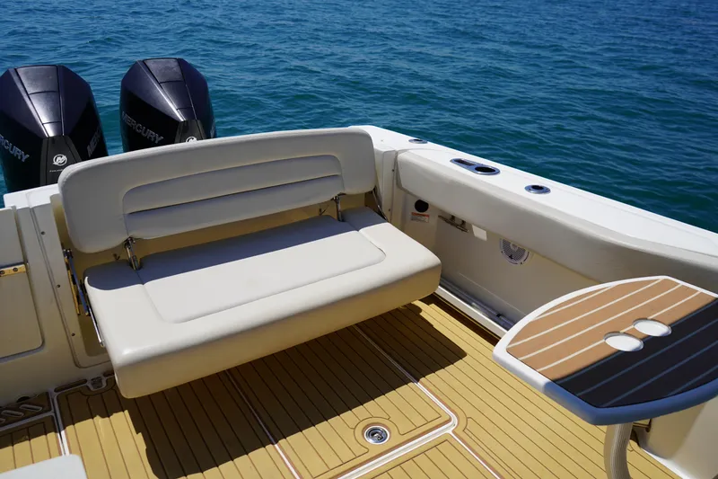 Slide: The Image of 2019 Boston Whaler 270 Vantage boat interior with seating and twin Mercury engines. - 20