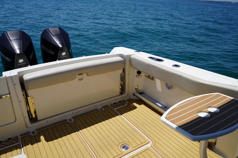 Slide: The Image of 2019 Boston Whaler 270 Vantage boat deck with twin Mercury engines on open water. - 21