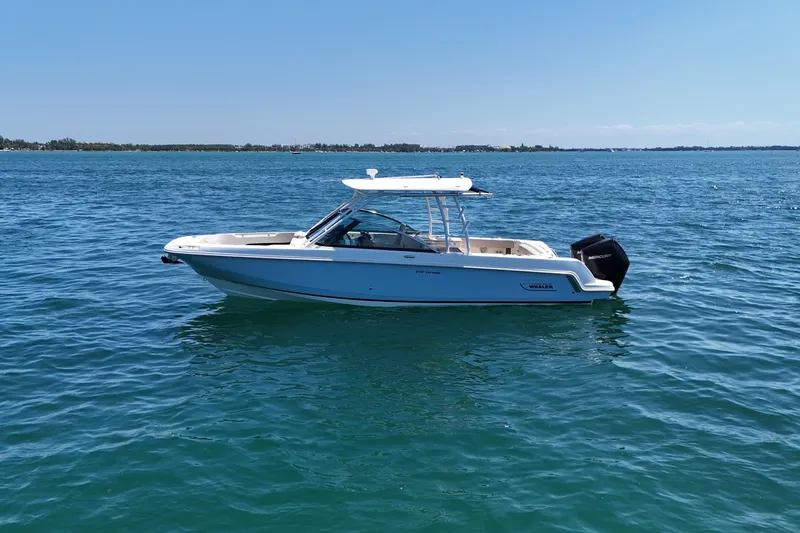 Slide: The Image of 2019 Boston Whaler 270 Vantage boat on calm blue water. - 4