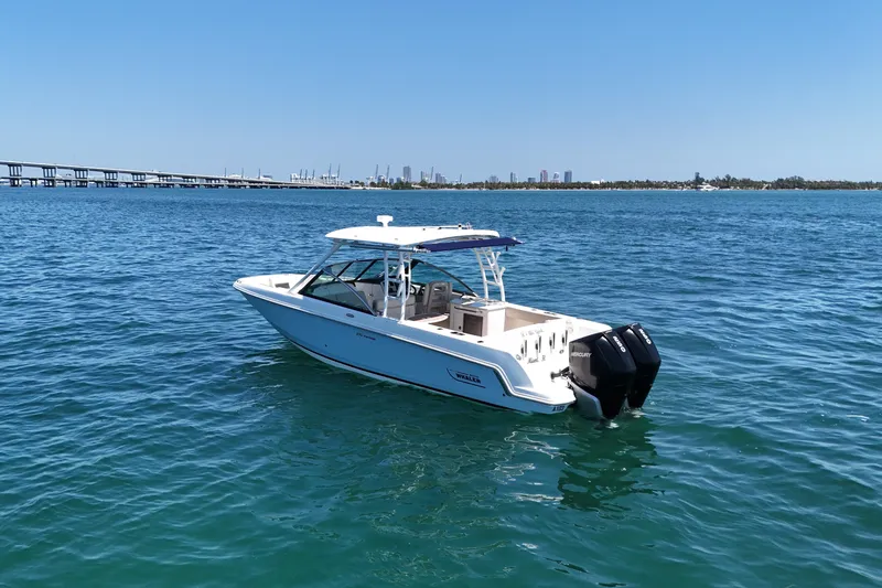 Slide: The Image of 2019 Boston Whaler 270 Vantage boat on calm blue water with city skyline in background. - 5