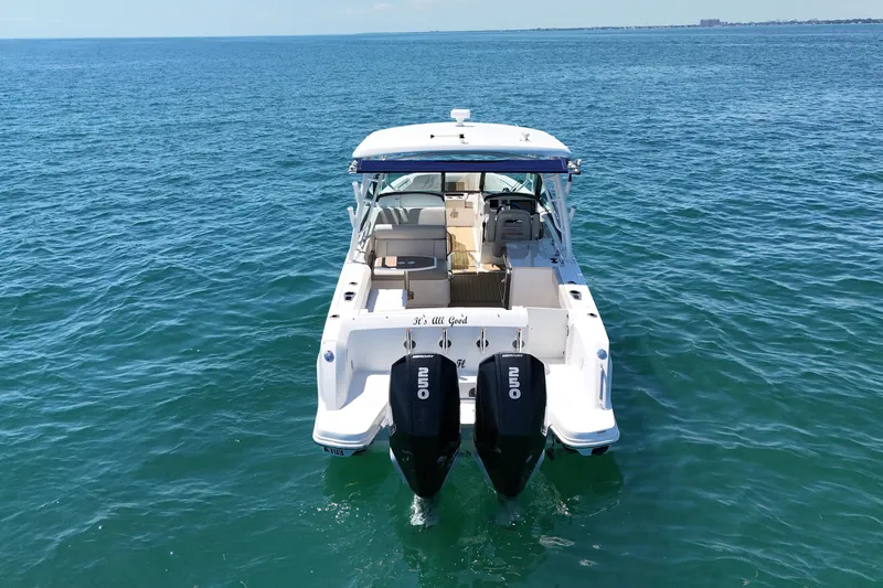 Slide: The Image of 2019 Boston Whaler 270 Vantage boat on open water, rear view with dual engines. - 7
