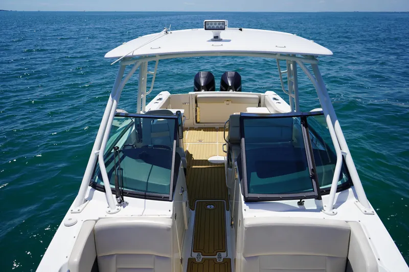 Slide: The Image of 2019 Boston Whaler 270 Vantage boat on open water, showcasing sleek design and dual engines. - 9