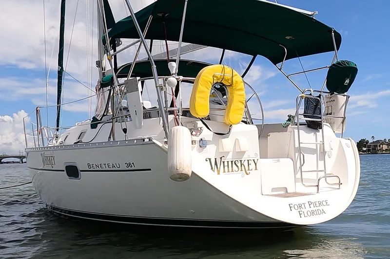 The Image of Beneteau Oceanis Clipper 361 sailboat docked, 2000 model, with lush greenery in the background. - 0