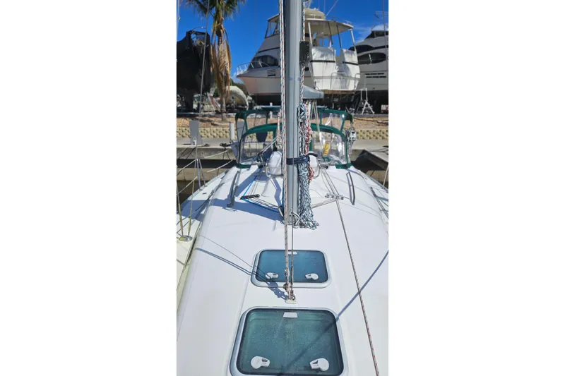 Slide: The Image of Beneteau Oceanis Clipper 361 sailboat, 2000 model, docked with green canopy and visible rigging. - 12