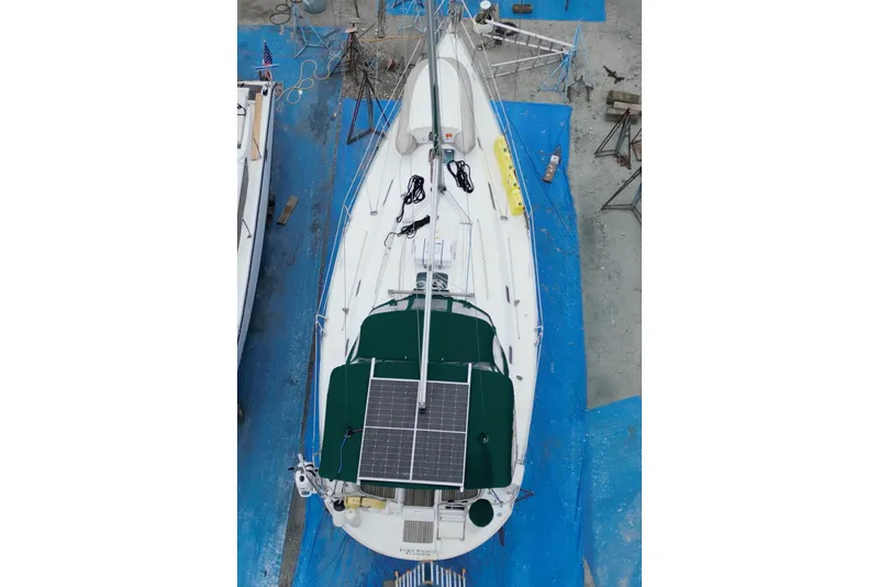 Slide: The Image of Beneteau Oceanis Clipper 361 sailboat, 2000 model, docked with green canopy and visible deck. - 2