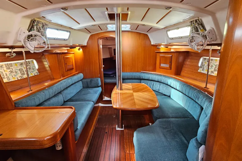 Slide: The Image of Interior of 2000 Beneteau Oceanis Clipper 361 yacht with wooden finish and blue seating. - 29