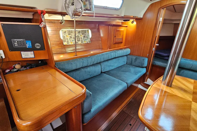 Slide: The Image of Interior of 2000 Beneteau Oceanis Clipper 361 yacht, featuring a well-equipped wooden kitchen. - 31