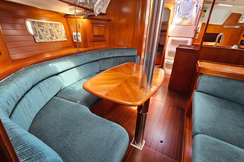 Slide: The Image of Interior of 2000 Beneteau Oceanis Clipper 361 yacht with wooden furnishings and blue seating. - 32