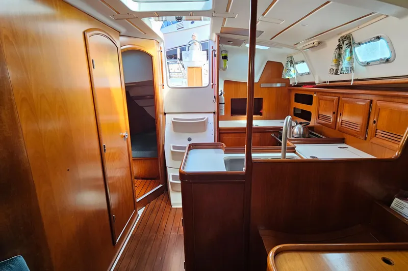 Slide: The Image of Interior of 2000 Beneteau Oceanis Clipper 361 yacht with wooden finish and blue seating. - 33