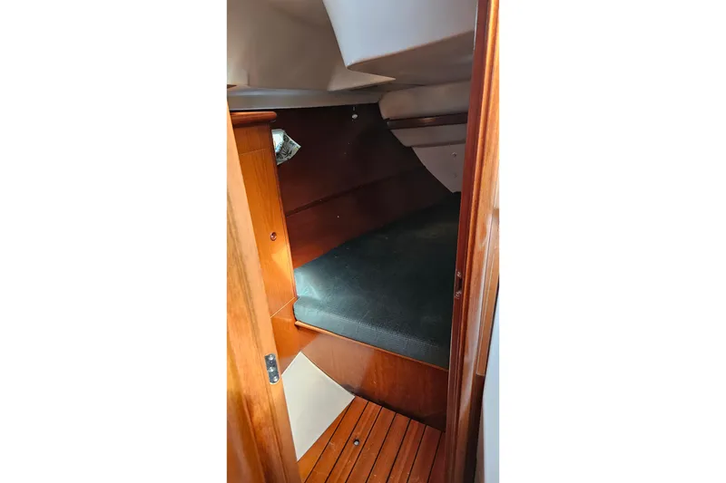 Slide: The Image of Cozy cabin interior of 2000 Beneteau Oceanis Clipper 361 sailboat with cushions and wood finish. - 42