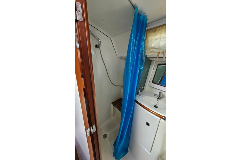 Slide: The Image of Engine compartment of a 2000 Beneteau Oceanis Clipper 361 sailboat, showcasing red engine components. - 52