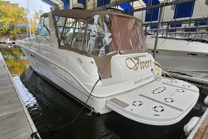 The Image of Sea Ray Sundancer 460 yacht, 2000 model, docked in a marina with canopy cover. - 0