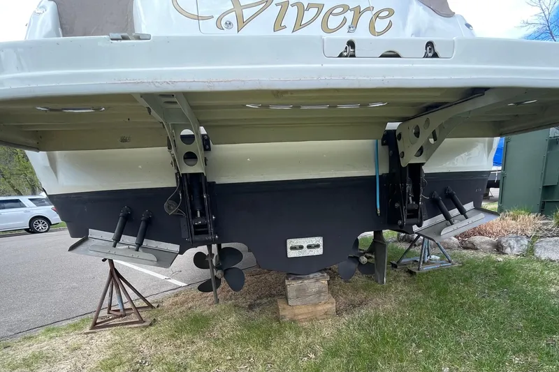 Slide: The Image of Rear view of a 2000 Sea Ray Sundancer 460 boat on stands, showing propellers and rudders. - 17