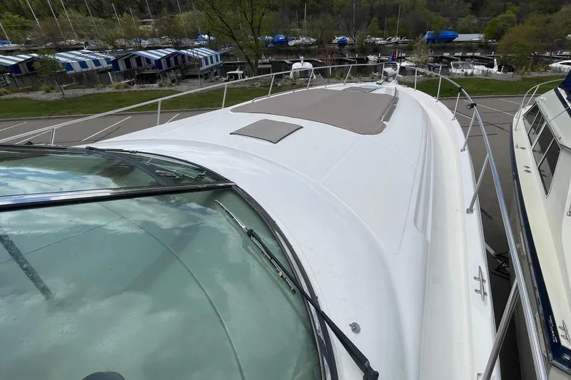 Slide: The Image of 2000 Sea Ray Sundancer 460 yacht docked at marina, showcasing sleek deck design. - 18