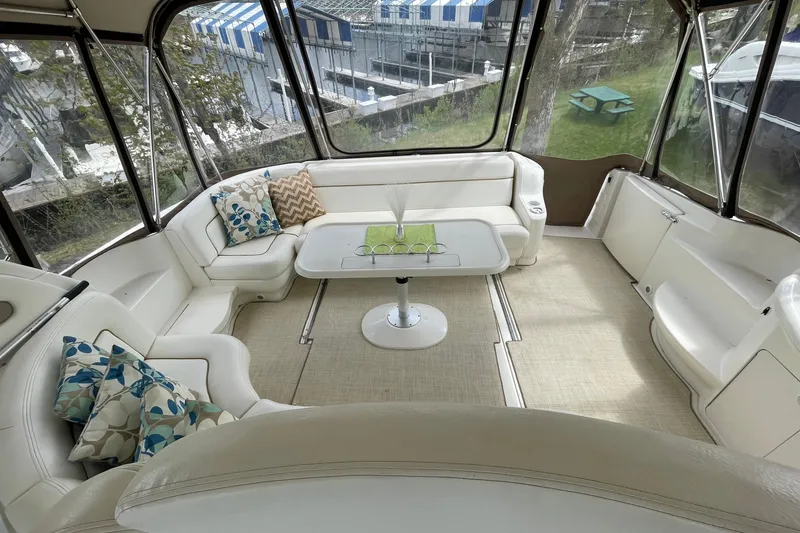 Slide: The Image of Interior of 2000 Sea Ray Sundancer 460 with white seating and decorative pillows. - 25