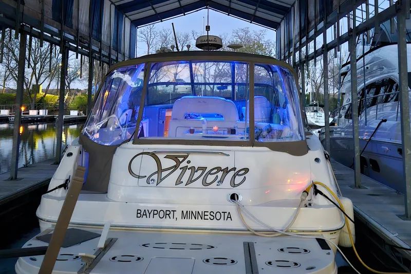Slide: The Image of Sea Ray Sundancer 460 yacht docked in Bayport, Minnesota, illuminated with blue lights. - 3