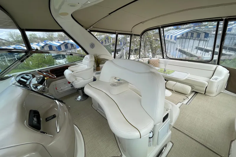 Slide: The Image of Interior view of a 2000 Sea Ray Sundancer 460 yacht cockpit with white seating. - 30