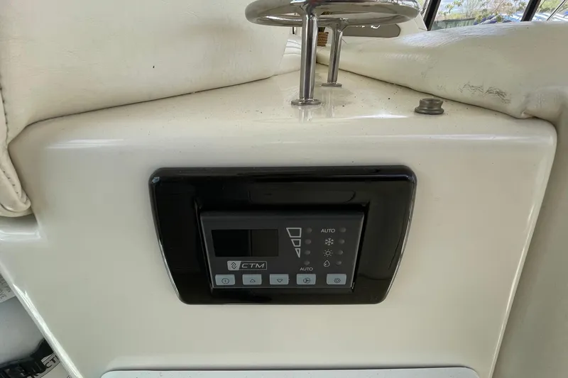 Slide: The Image of Control panel of a 2000 Sea Ray Sundancer 460 yacht with switches and system monitor. - 35