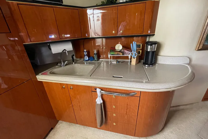 Slide: The Image of Interior of 2000 Sea Ray Sundancer 460 yacht with elegant wood cabinetry and plush seating. - 44