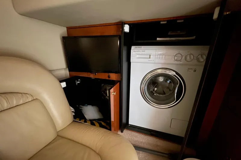 Slide: The Image of Interior of a 2000 Sea Ray Sundancer 460 yacht with beige leather seating and decorative pillows. - 48