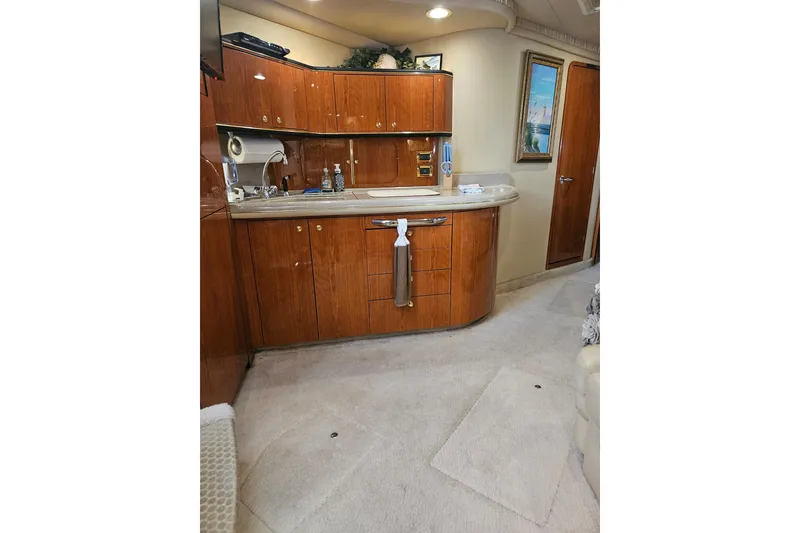 Slide: The Image of Interior of 2000 Sea Ray Sundancer 460 yacht with wooden cabinetry and modern amenities. - 5