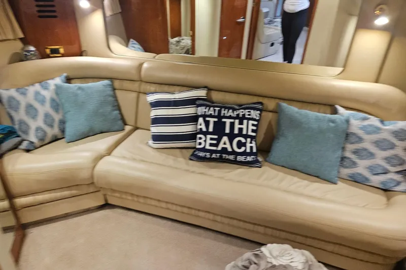 Slide: The Image of Luxurious interior of 2000 Sea Ray Sundancer 460 with beige leather seating and decorative pillows. - 6