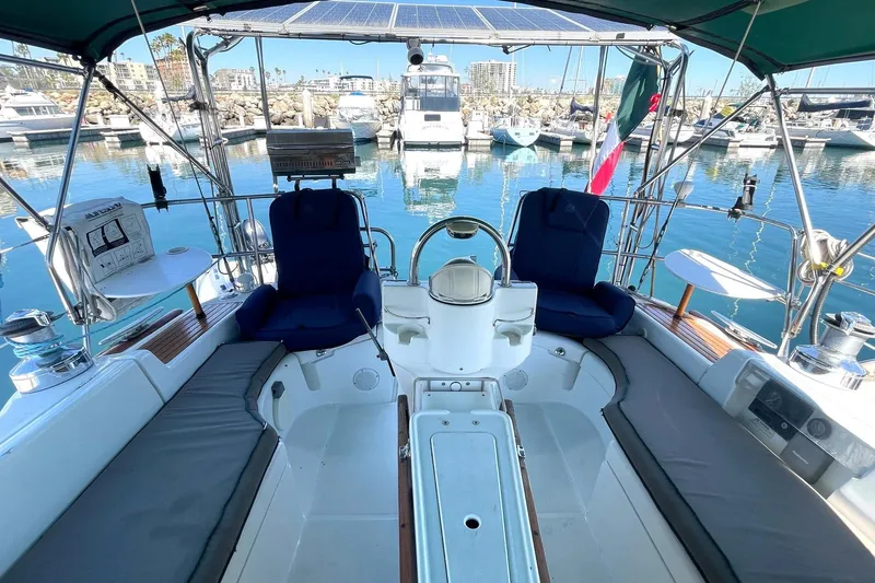 Slide: The Image of Cockpit of 2007 Beneteau 423 sailboat docked in marina, featuring seating and steering wheel. - 10