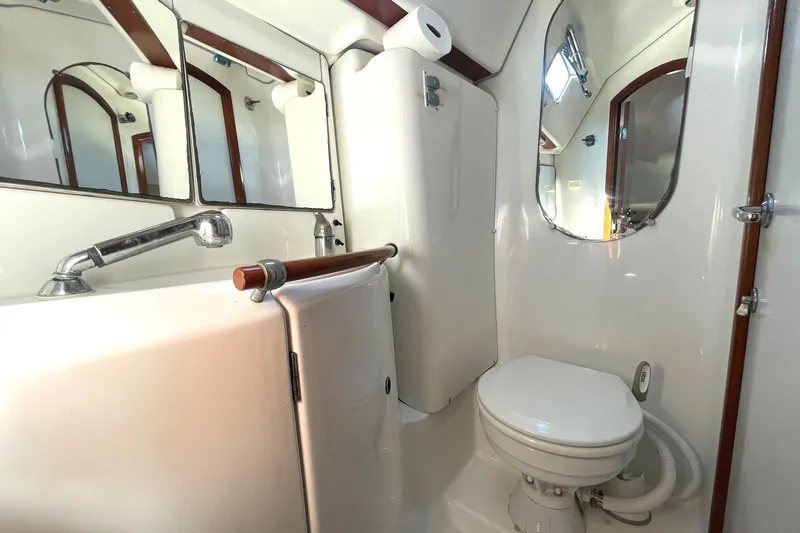 Slide: The Image of Bathroom interior of 2007 Beneteau 423 yacht, featuring sink, toilet, and mirror. - 19