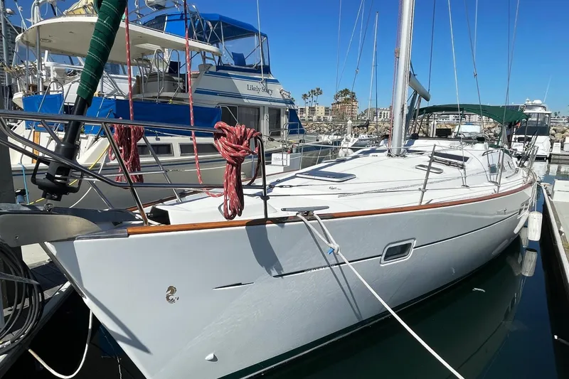 Slide: The Image of 2007 Beneteau 423 sailboat docked in marina under clear blue sky. - 2
