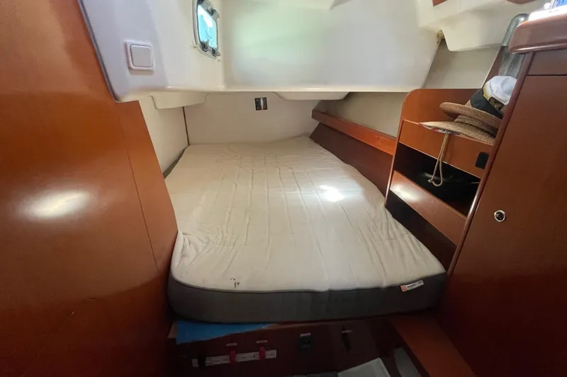 Slide: The Image of Cozy cabin interior of 2007 Beneteau 423 sailboat with bed and wooden storage. - 21