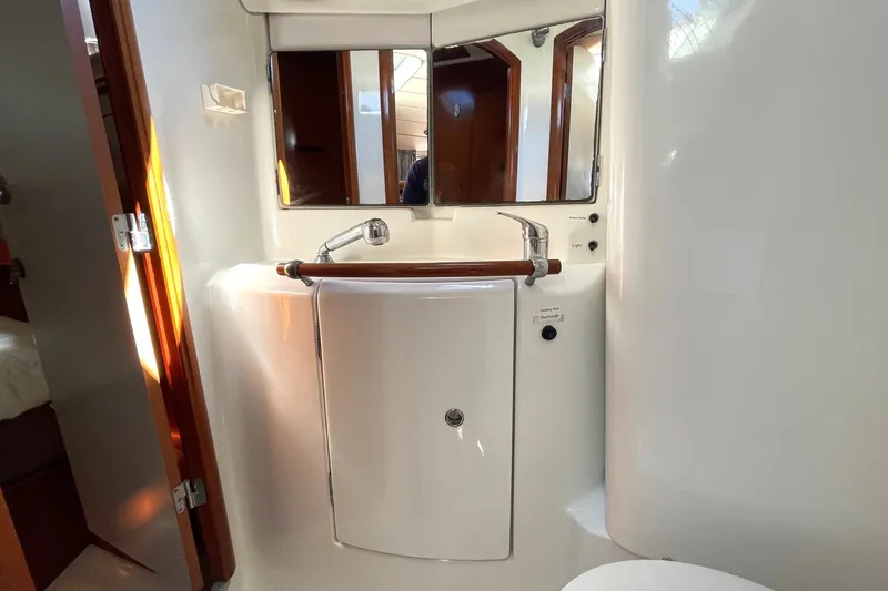 Slide: The Image of Bathroom interior of a 2007 Beneteau 423 yacht, featuring a compact sink and mirror. - 25