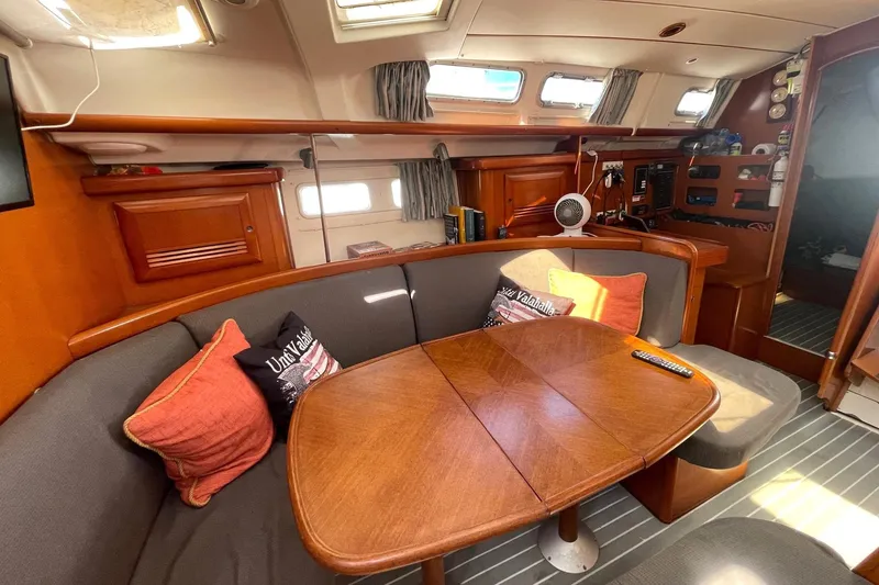 Slide: The Image of Interior of 2007 Beneteau 423 yacht with cozy seating and wooden table. - 29