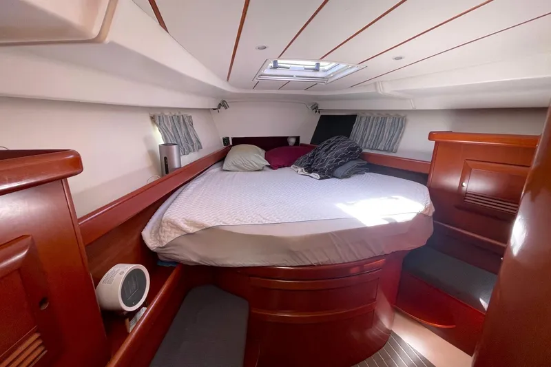 Slide: The Image of Luxurious cabin interior of 2007 Beneteau 423 yacht with cozy bed and wooden finish. - 32