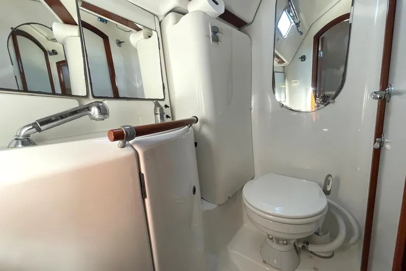 Slide: The Image of Bathroom interior of 2007 Beneteau 423 yacht, featuring sink, toilet, and mirror. - 41