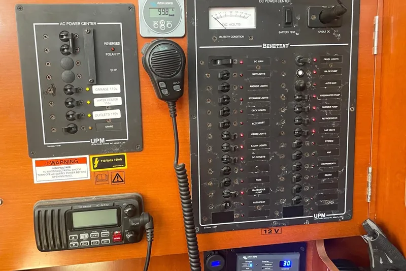 Slide: The Image of Electrical control panel on a 2007 Beneteau 423 sailboat, featuring various switches and gauges. - 42