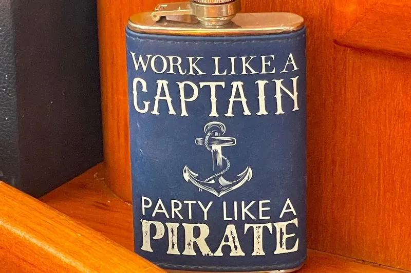 Slide: The Image of Blue flask with nautical theme, "Work Like a Captain, Party Like a Pirate," on Beneteau 423, 2007. - 43