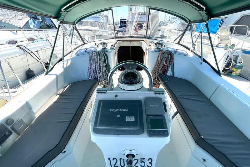 Slide: The Image of Cockpit of 2007 Beneteau 423 sailboat with navigation equipment and seating. - 46