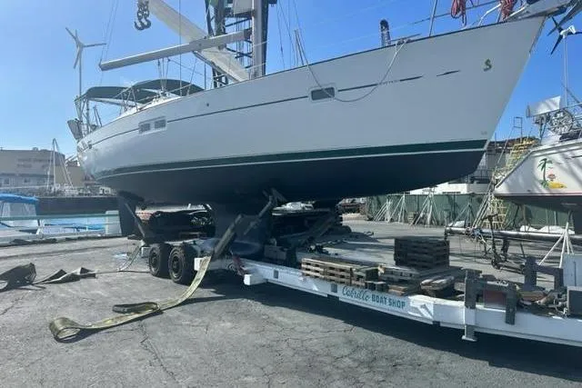 Slide: The Image of Sailboat Beneteau 423, 2007 model, on trailer at boatyard for maintenance. - 48