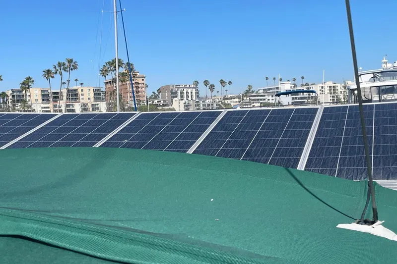 Slide: The Image of Solar panels on a 2007 Beneteau 423 yacht with cityscape and palm trees in the background. - 7