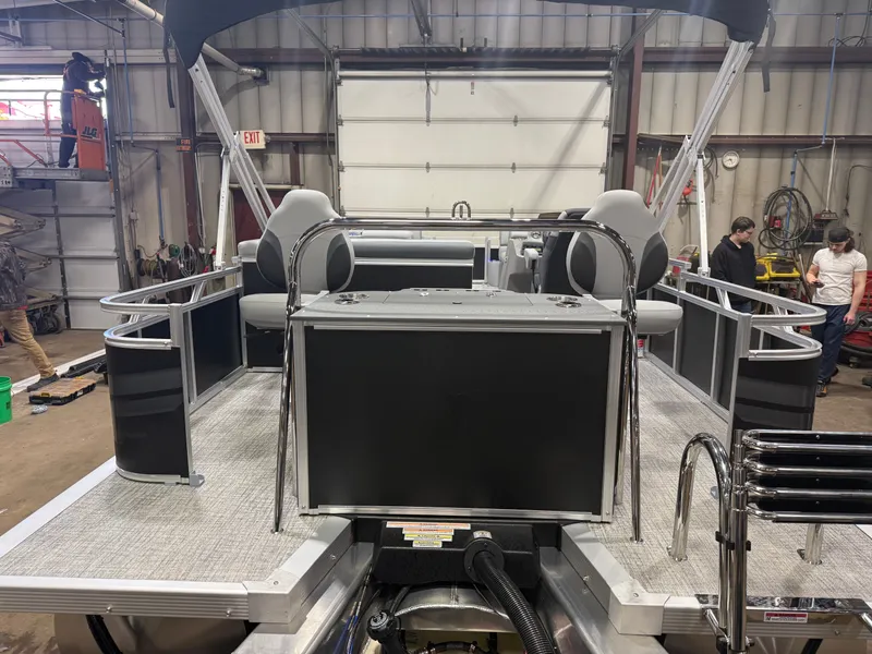 Slide: The Image of 2026 Tahoe Sport 2385 Tritoon in indoor workshop setting. - 45