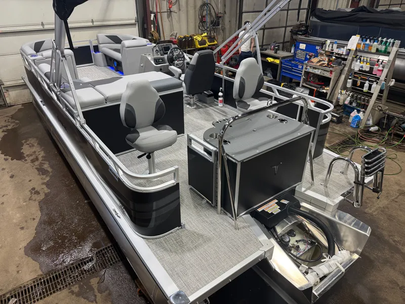 Slide: The Image of 2026 Tahoe Sport 2385 Tritoon with Honda 4-Stroke EFI in workshop area. - 48