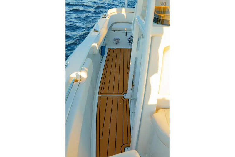 Slide: The Image of 2022 Sea Hunt Ultra 229 boat deck with teak flooring, ocean view. - 11