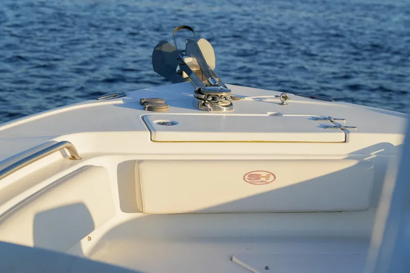 Slide: The Image of Bow of 2022 Sea Hunt Ultra 229 boat with anchor, on calm water. - 12