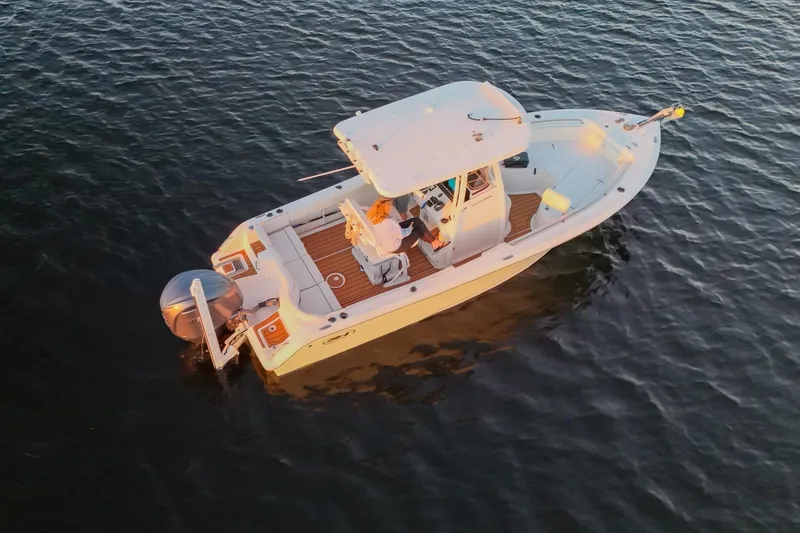 Slide: The Image of 2022 Sea Hunt Ultra 229 boat on calm water, viewed from above. - 16