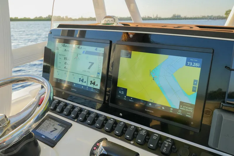 Slide: The Image of Dashboard of 2022 Sea Hunt Ultra 229 boat with Garmin navigation displays. - 3