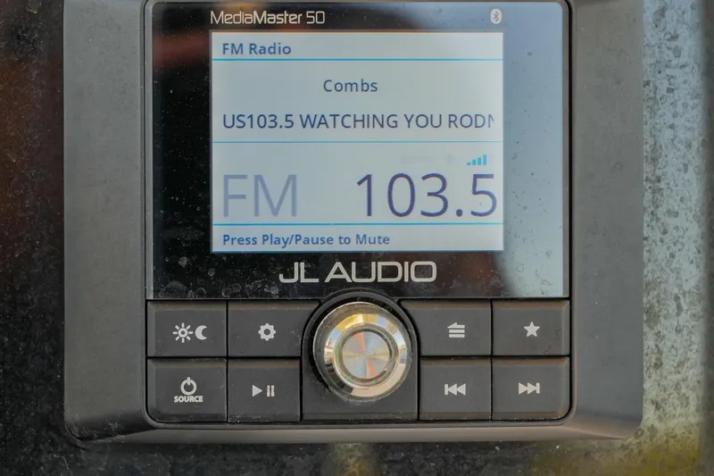 Slide: The Image of JL Audio MediaMaster 50 displaying FM radio station 103.5 on a 2022 Sea Hunt Ultra 229. - 6